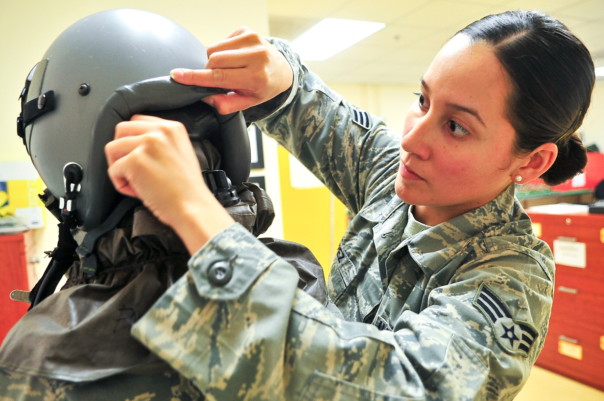 Senior Airman Jennifer Lopez, 51st Operations Support Squadron aircrew flight equipment journeyman, checks the seal of an aircrew chemical defense system April 10, 2012. The defense system is used by pilots who may enter a harmful chemical environment. (U.S. Air Force photo/Senior Airman Adam Grant)