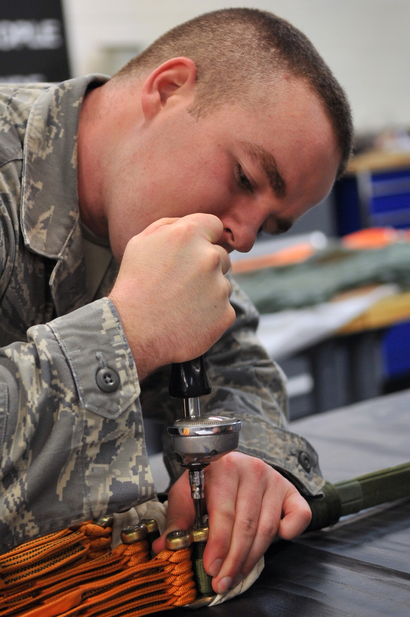 Airman 1st Class Taylor Smith, 51st Operations Support Squadron aircrew flight equipment journeyman, torques the counter links on a parachute here April 10, 2012. (U.S. Air Force photo/Staff Sgt. Craig Cisek)