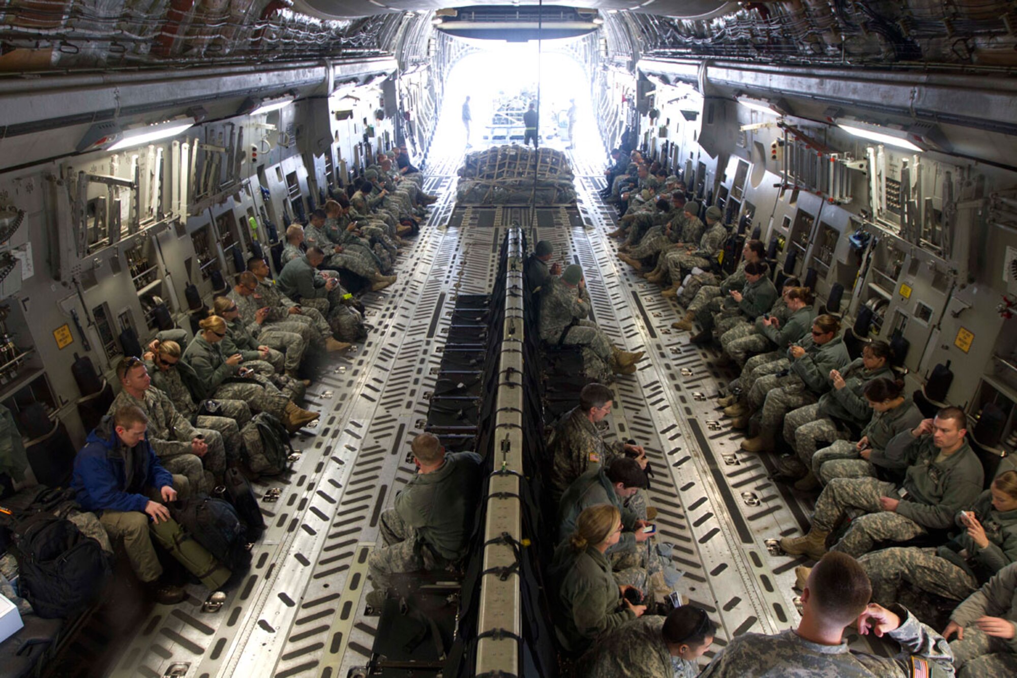 Arctic Care participants sit onboard an Air Force C-17 Globemaster III cargo aircraft at Joint Base Elmendorf-Richardson Monday before heading to Nome. Medical professionals from the Alaska National Guard, Arizona National Guard, Colorado National Guard, Army Reserve, Navy Reserve and active duty will spend the next two weeks providing medical care to Alaskans in 16 remote communities. (Alaska National Guard photo/Air Force Maj. Guy Hayes)