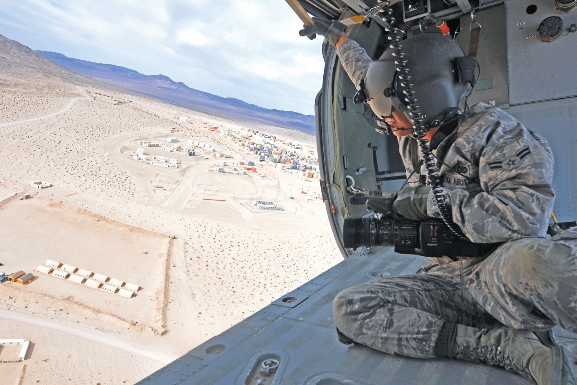 Airman 1st Class Armando Aparicio documents Air Force training in an HH-60G Pave Hawk helicopter during Exercise Mojave Viper March 16. The 210th and 212th
rescue squadrons, Alaska Air National Guard, participated in Exercise Mojave Viper
with the 3rd Battalion 8th Marines, Camp Lejeune, N.C., before they deploy together
to Afghanistan. (U.S. Air Force photo/Staff Sgt. Cynthia Spalding)