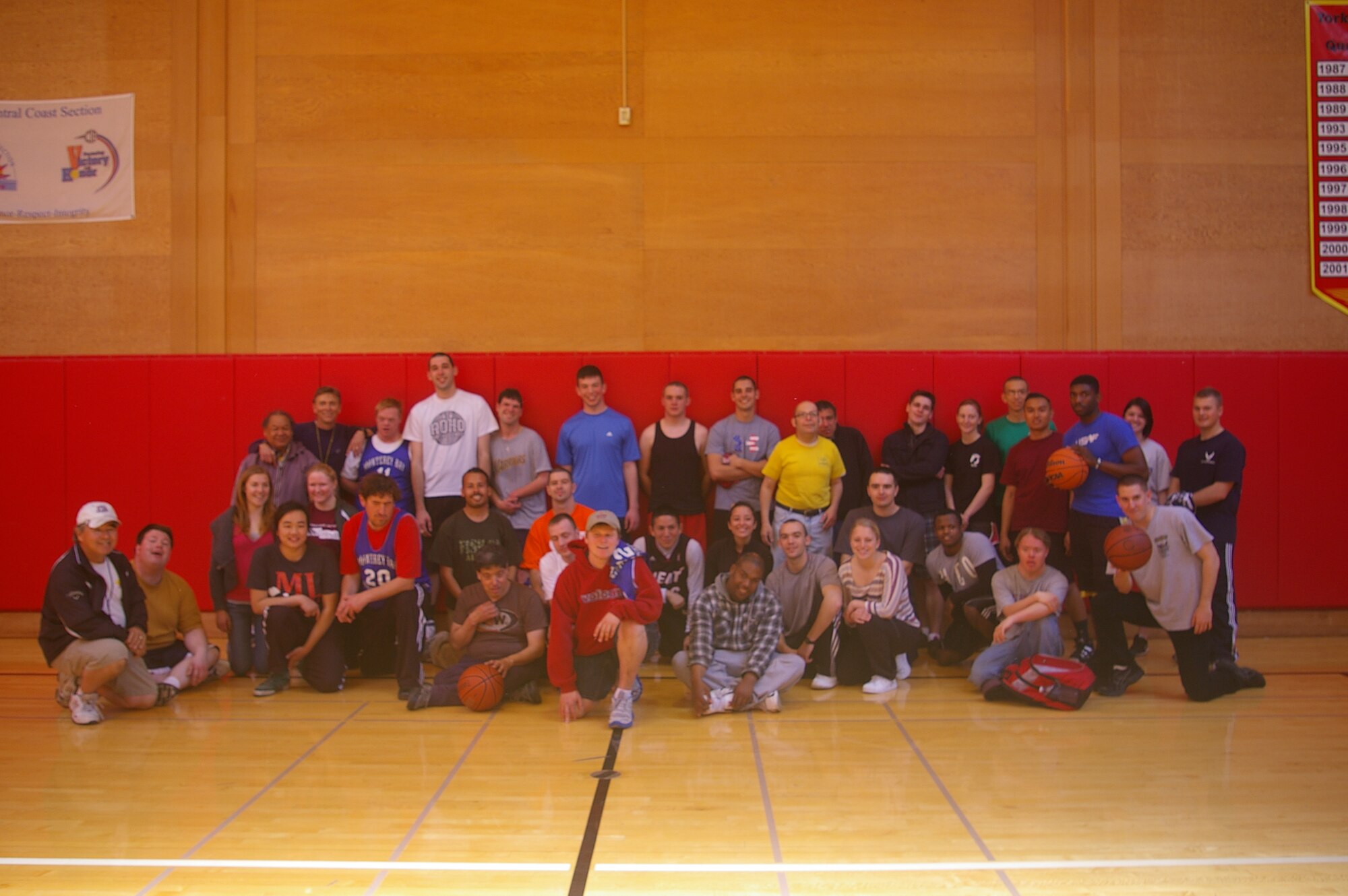 PRESIDIO OF MONTEREY, Calif -- Airmen from the 311th Training Squadron, 517th Training Group, Presidio of Monterey, Calif., pose with Special Olympics members, during basketball training, recently. The practice sessions earned the team a “Silver” medal during the Northern California Special Olympics last month. (Courtesy photo)