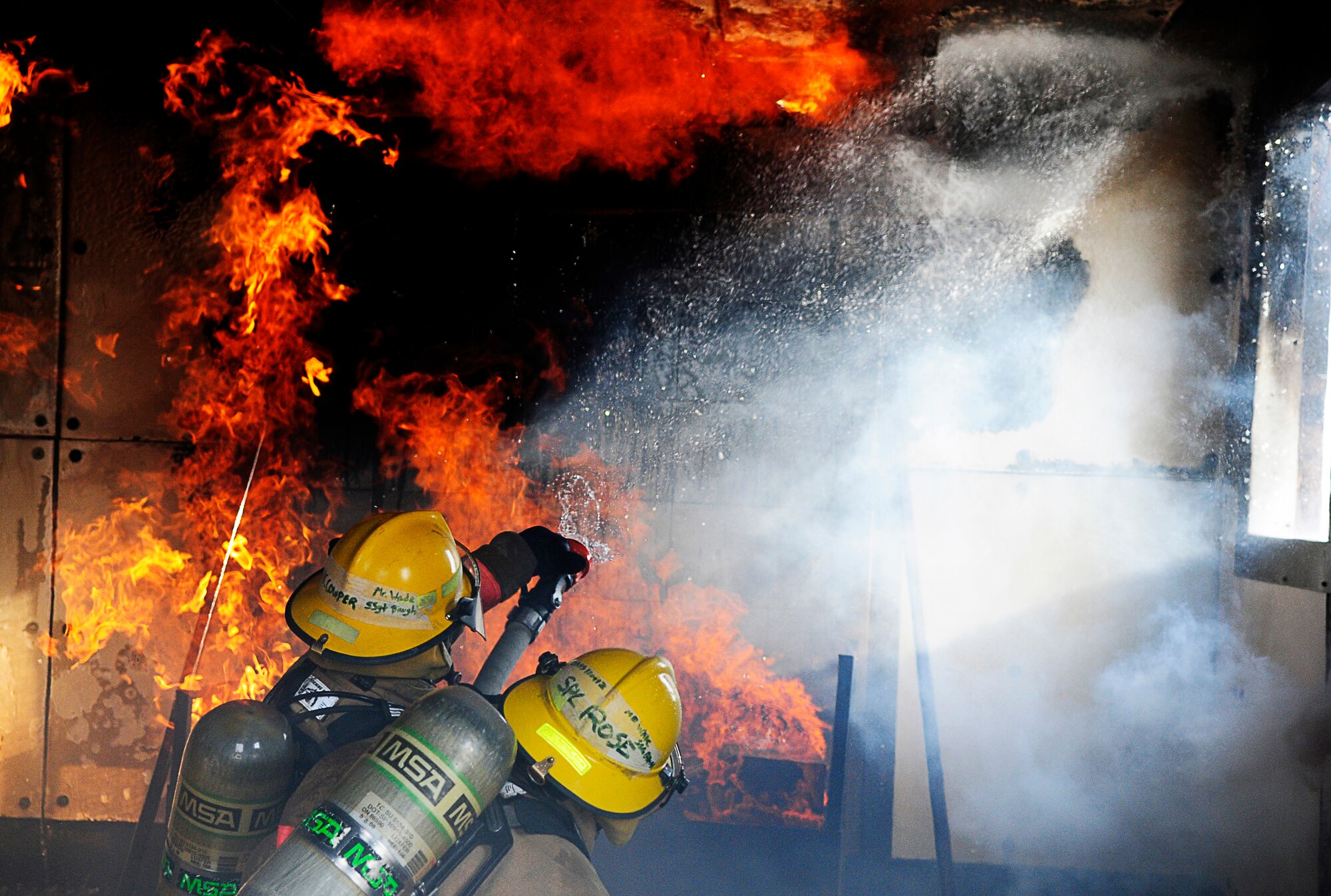 GOODFELLOW AIR FORCE BASE, Texas -- Students from the Louis F. Garland DOD Fire Academy learn to battle interior fires. (U.S. Air Force photo/Staff Sgt. Austin Knox)