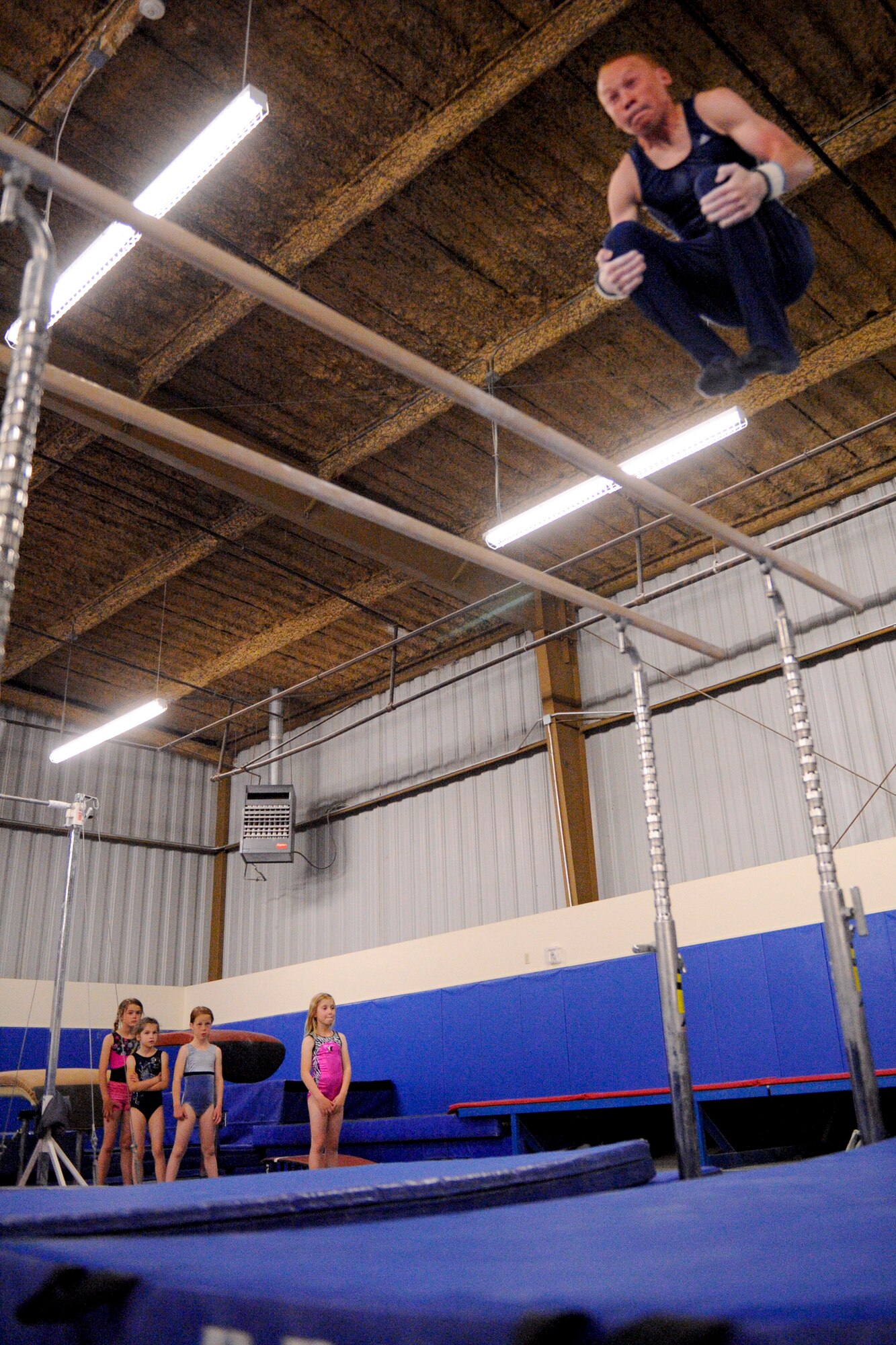 VANDENBERG AIR FORCE  BASE, Calif. -- Ben Jones, son of Col. Barbara Jones 30th Medical Group commander, does a flip off of the parallel bars at the youth center annex here Tuesday, April 11, 2012. Jones will be competing in California's Southern Division Men's State Gymnastics meet as a level nine gymnast for the 13 to 14-year old age group. (U.S. Air Force photo/Staff Sgt. Levi Riendeau)
