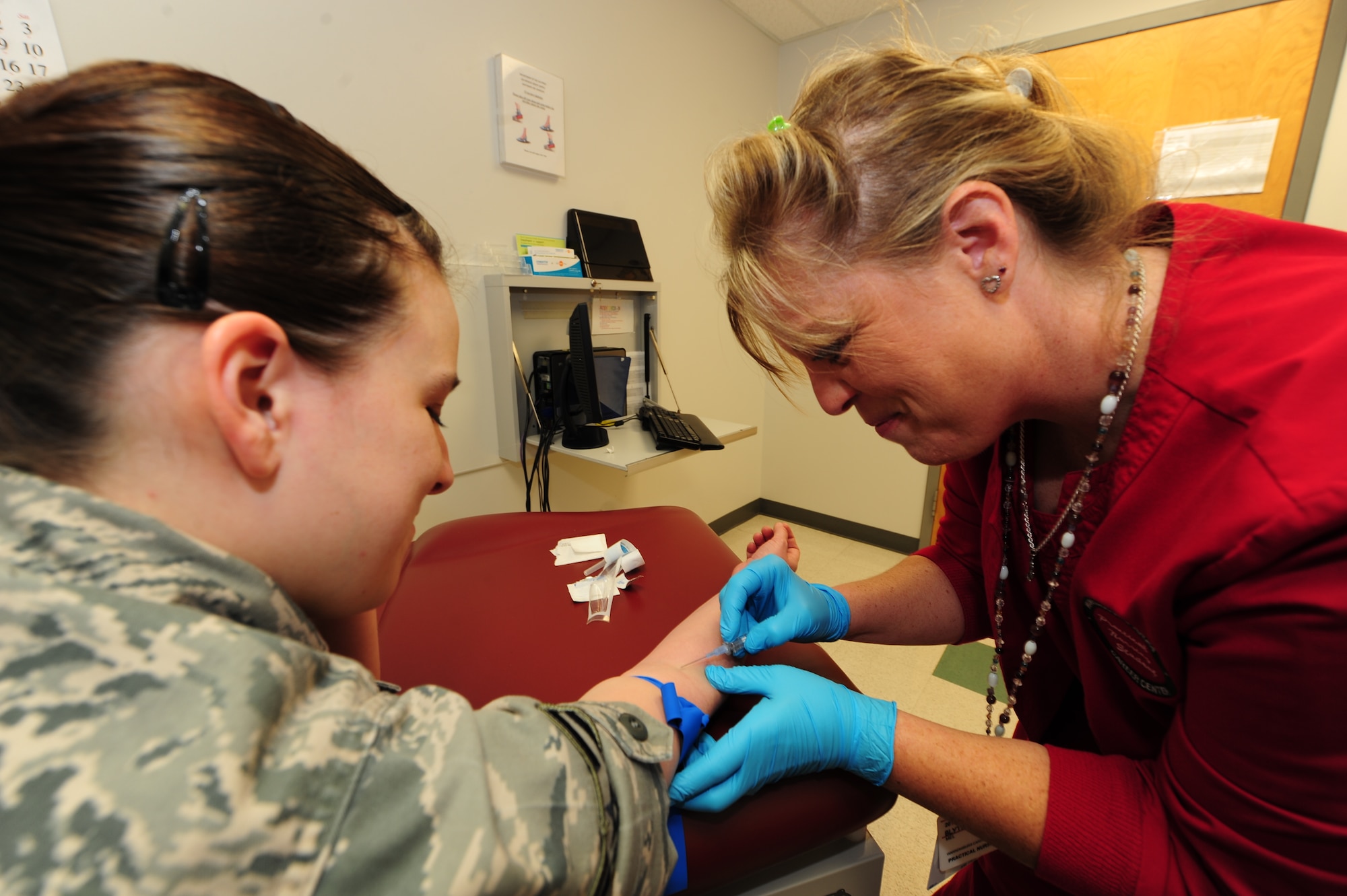 WHITEMAN AIR FORCE BASE, Mo. -- Airman 1st Class Brandy Ortiz, 509th Medical Operations Squadron aerospace medical technician, gets her blood taken by Mel Blyth, Warrensburg Area Career Center licensed practical nursing student, April 4. Patients get their blood taken to ensure they have the proper nutrients being delivered to their organs. (U.S. Air Force photo/Senior Airman Nick Wilson)
