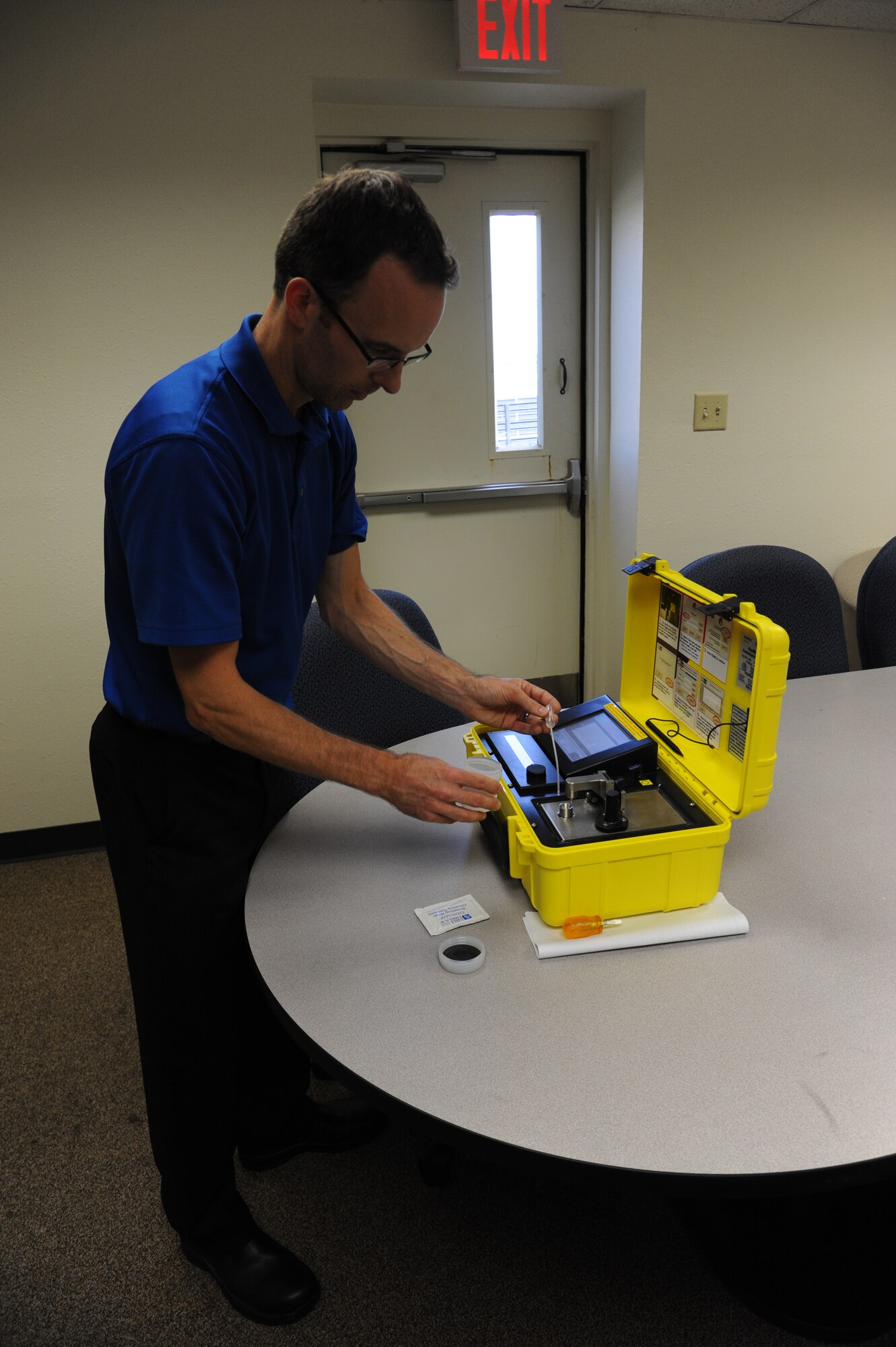 Jeremy Kirk, Defense Support Services emergency management specialist, uses a piece of equipment called the Hazmat ID to test an unknown liquid April 4, 2012. Kirk was the first to receive the Air Force Certified All-Hazards Responder certification in the Air Force. (U.S. Air Force photo/Senior Airman Adawn Kelsey)