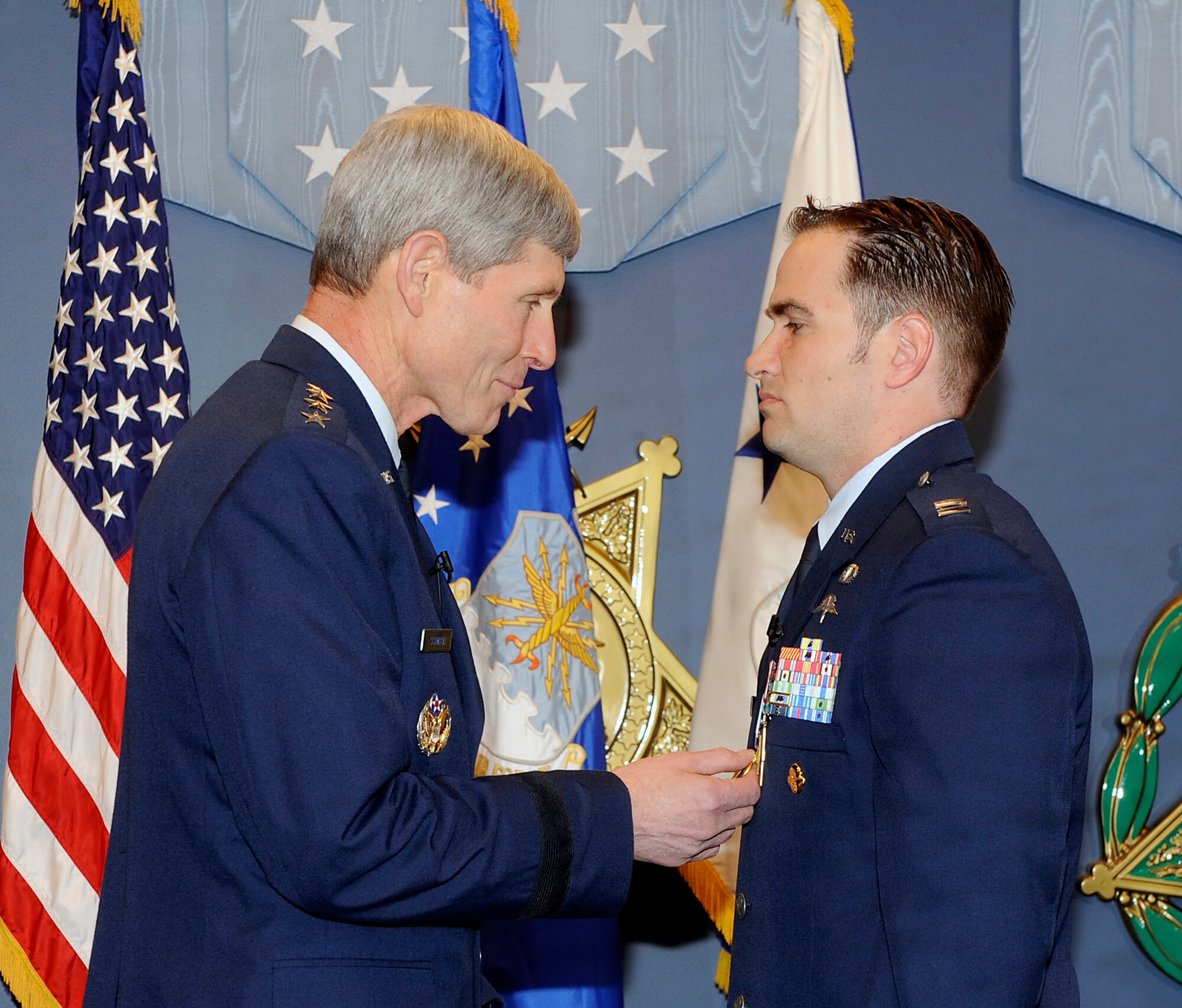 Air Force Chief of Staff Gen. Norton Schwartz pins the Air Force Cross on Capt. Barry Crawford during a ceremony in the Pentagon's Hall of Heroes in Washington, D.C., on April 12, 2012.  (U.S. Air Force photo/Andy Morataya)