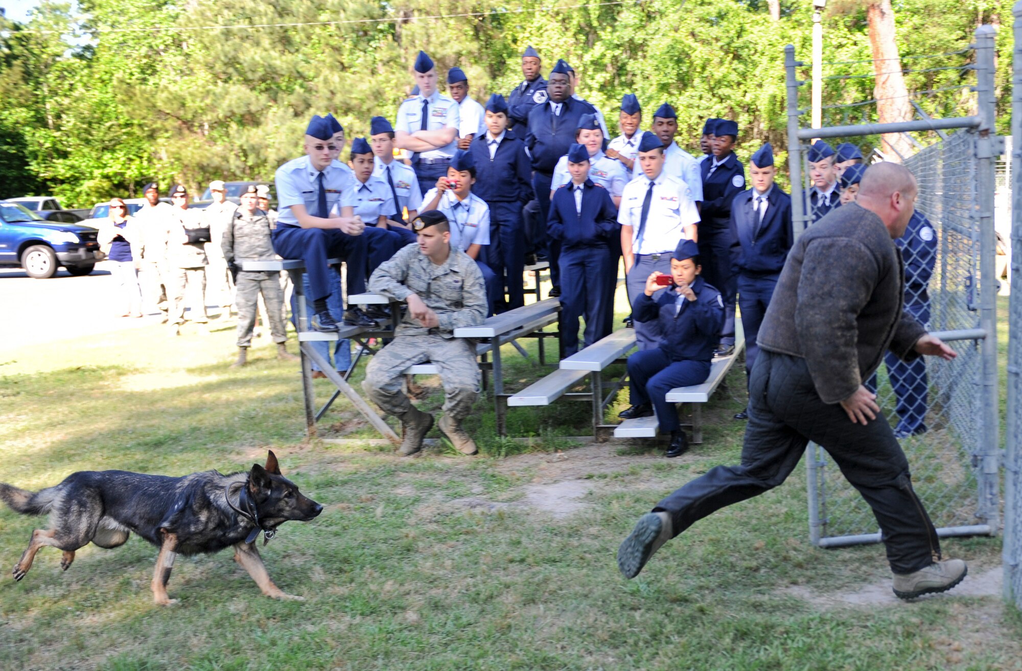U.S. Air Force Tech. Sgt. David Smith, 23d Security Forces Squadron military working dog handler, runs from a MWD at Moody Air Force Base, Ga., April 12, 2012. Members of Tift County High School attended the demonstration to learn more about MWD handlers. (U.S. Air Force photo by Airman 1st Class Douglas Ellis/Released)
