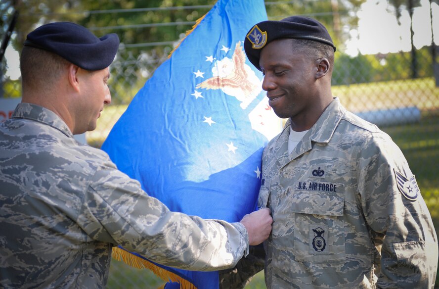U.S. Air Force Staff Sgt. Ronald Young, 23d Security Forces Squadron military working dog handler, receives the Combat Action Medal at Moody Air Force Base, Ga., April 12, 2012. Young was in grave danger while under direct small arms fire while in Afghanistan. (U.S. Air Force photo by Airman 1st Class Douglas Ellis/Released)
