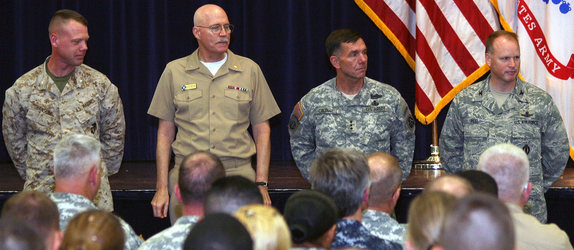 U.S. Marine Corps Lt. Col. Jeff Hanson, Joint Electronic Warfare Center, Joint Base San Antonio-Lackland, joins Navy Rear Adm. William Kiser, Medical Education and Training Campus commandant, JBSA-Fort Sam Houston; Army Lt. Gen. William B. Caldwell IV, U.S. Army North commanding general and senior commander, JBSA-Fort Sam Houston and Camp Bullis; and Air Force Col. Scott Peel, 902nd Mission Support Group commander, JBSA-Randolph, as they prepare to sign a Sexual Assault Awareness Month proclamation April 4 at the Roadrunner Community Services building on Fort Sam Houston. The leaders represented the four services during the kickoff of the JBSA SAAM. Peel represented Air Force Gen. Edward A. Rice Jr., Air Education and Training Command commander. (U.S. Army photo by Sgt. Lee Ezzell)