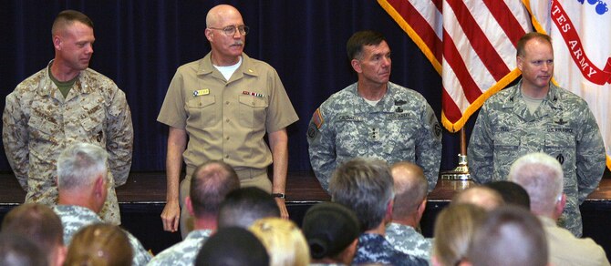 U.S. Marine Corps Lt. Col. Jeff Hanson, Joint Electronic Warfare Center, Joint Base San Antonio-Lackland, joins Navy Rear Adm. William Kiser, Medical Education and Training Campus commandant, JBSA-Fort Sam Houston; Army Lt. Gen. William B. Caldwell IV, U.S. Army North commanding general and senior commander, JBSA-Fort Sam Houston and Camp Bullis; and Air Force Col. Scott Peel, 902nd Mission Support Group commander, JBSA-Randolph, as they prepare to sign a Sexual Assault Awareness Month proclamation April 4 at the Roadrunner Community Services building on Fort Sam Houston. The leaders represented the four services during the kickoff of the JBSA SAAM. Peel represented Air Force Gen. Edward A. Rice Jr., Air Education and Training Command commander. (U.S. Army photo by Sgt. Lee Ezzell)