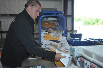 David Cason, Joint Base San Antonio-Randolph Recycling Center manager, sifts through paper before it goes through the shredder April 10 at the center. Cason has been the recycling center manager for more than a year. (U.S. Air Force photo by Airman 1st Class Alexis Siekert) 