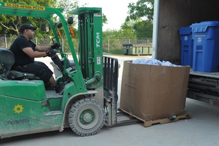 Rene Hernandez, Joint Base San Antonio-Randolph Recycling Center technician, transports recycled paper to be baled April 10 at the center. Once the recycling bins are emptied, the cardboard boxes are placed next to each other to be processed. (U.S. Air Force photo by Airman 1st Class Alexis Siekert)