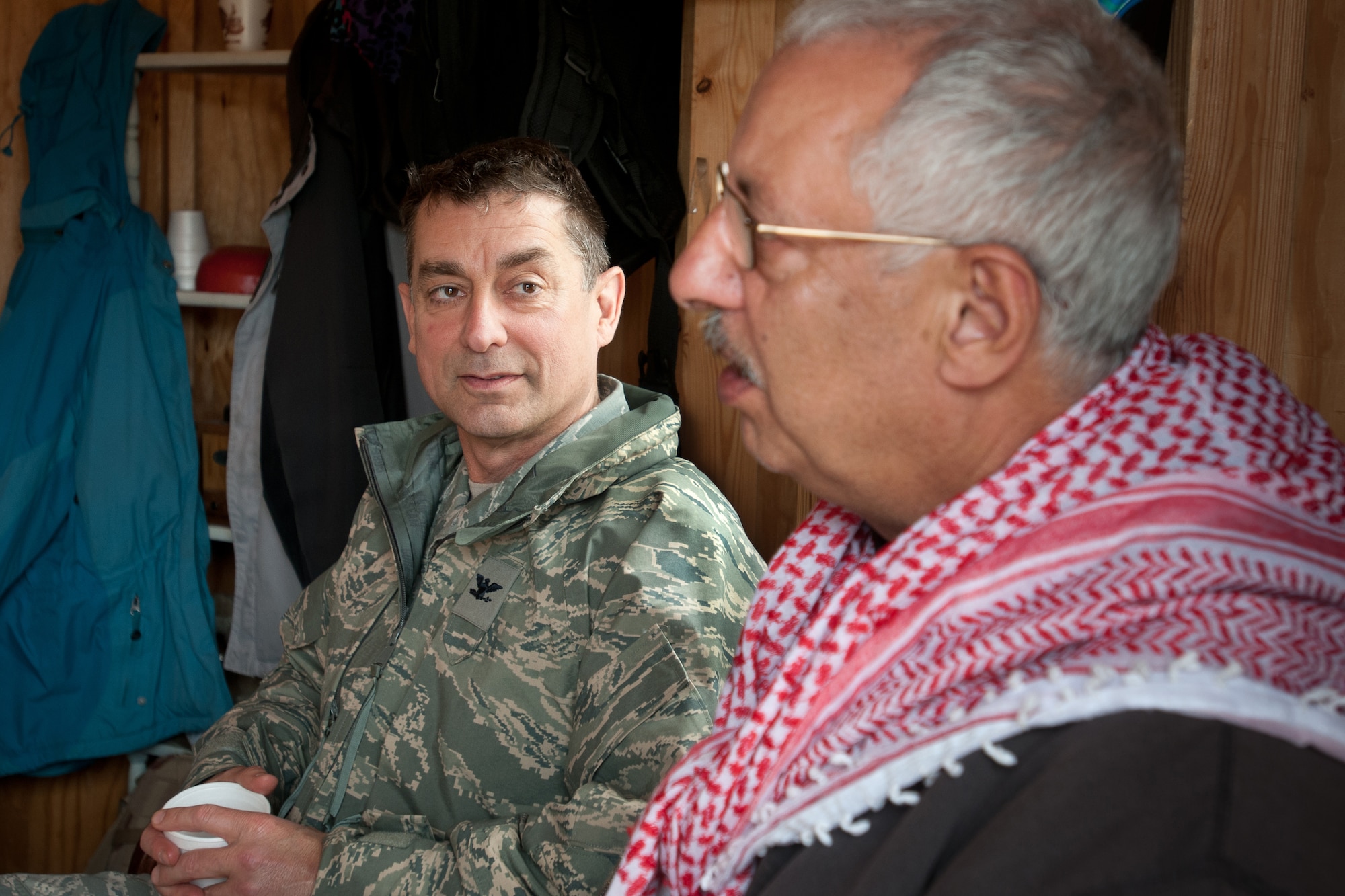 Col. Warren Hurst, commander of the Kentucky Air National Guard's 123rd Contingency Response Group, meets for tea with an actor playing the role of town mayor in the fictional village of Sabor, Nessor, on March 28, 2012. Hurst was participating in Eagle Flag, an exercise designed to simulate a deployed environment at Joint Base McGuire-Dix-Lakehurst, N.J. (U.S. Air Force photo by Maj. Dale Greer)