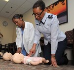 Staff Sgt. Andria King, (left) 359th Dental Squadron technician, and Lt. Col. Patricia John, 359th MDOS chief nurse, perform CPR during refresher training April 2 at the Joint Base San Antonio-Randolph, Texas Clinic. (U.S. Air Force Photo by Don Lindsey)
