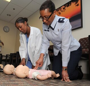 Staff Sgt. Andria King, (left) 359th Dental Squadron technician, and Lt. Col. Patricia John, 359th MDOS chief nurse, perform CPR during refresher training April 2 at the Joint Base San Antonio-Randolph, Texas Clinic. (U.S. Air Force Photo by Don Lindsey)
