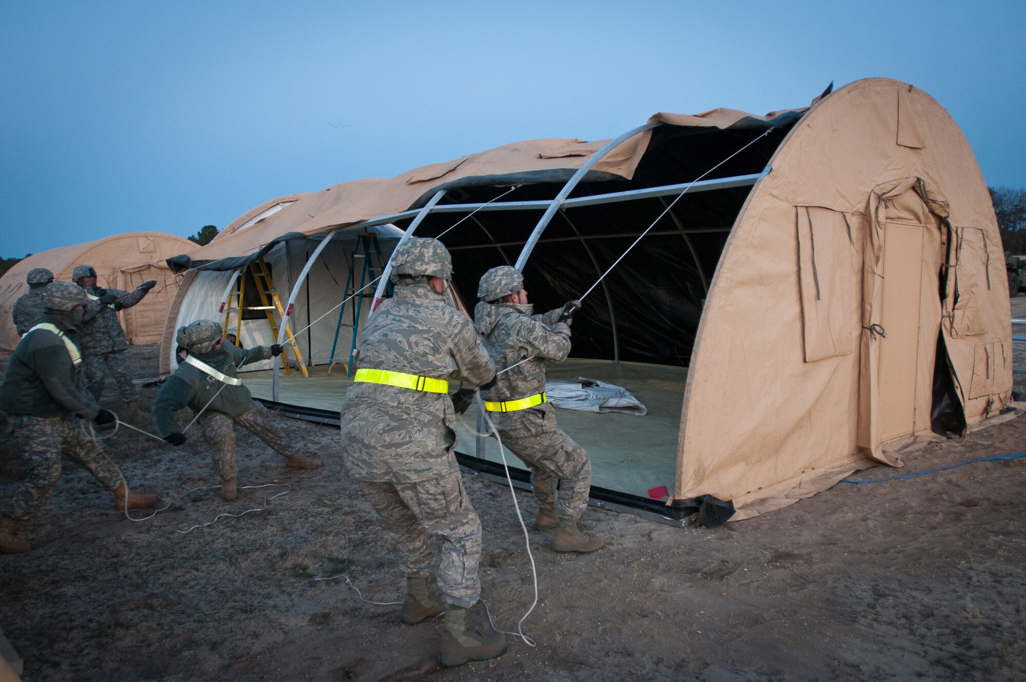 Airmen from the Kentucky Air National Guard's 123rd Contingency Response Group set up an Alaskan Shelter tent at Joint Base McGuire-Dix-Lakehurst, N.J., March 26, 2012, during Exercise Eagle Flag. More than 80 Airmen from the Kentucky Air Guard have joined forces with over 50 active-duty Army troops and Air Guardsmen from New Jersey and Mississippi to establish an aerial port at Lakehurst Naval Air Engineering Station within 24 hours of arrival. Inspectors from U.S. Transportation Command will evaluate the performance of the Kentucky unit during the exercise. (U.S. Air Force photo by Maj. Dale Greer)
