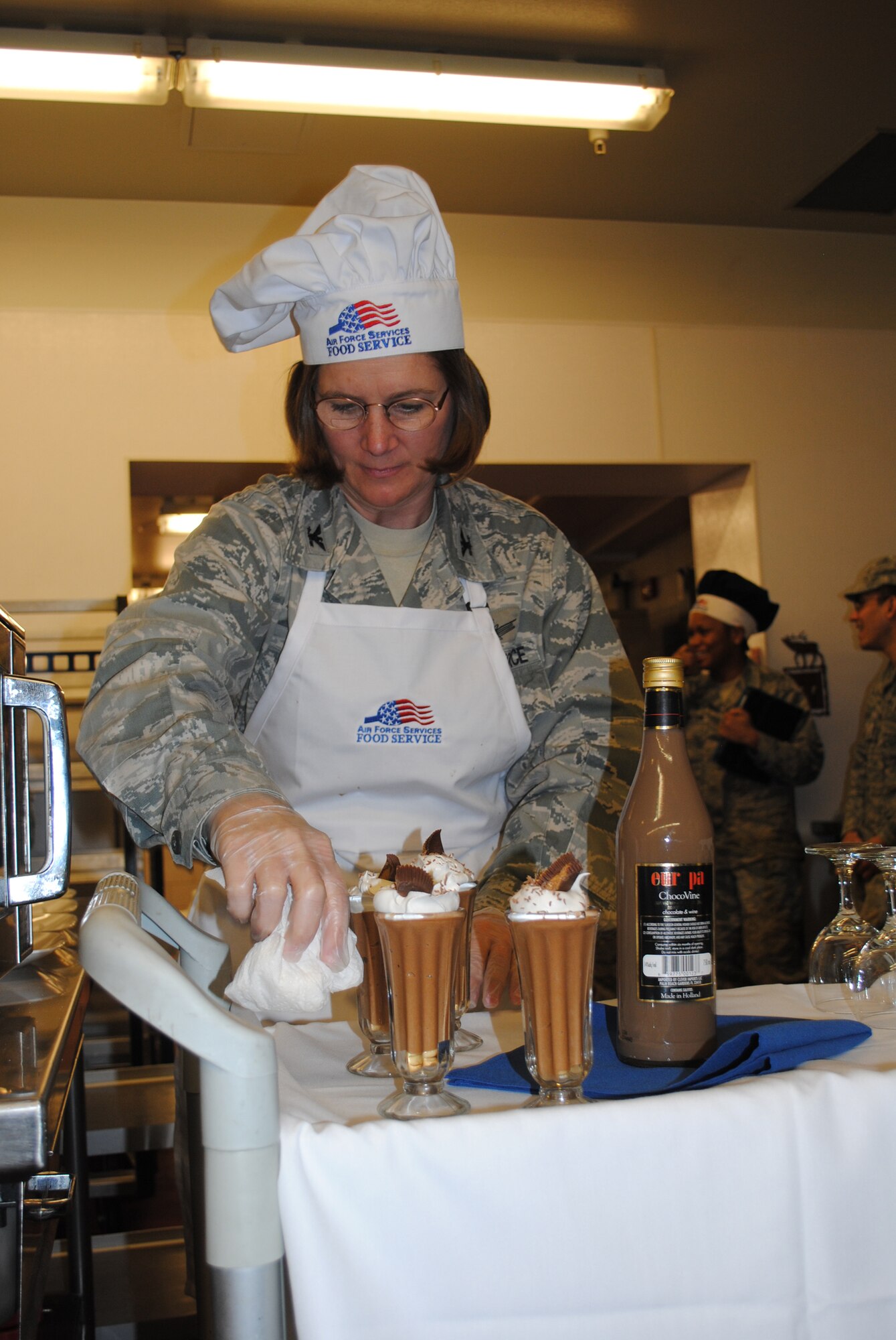 Col. Angela Stout, 341st Mission Support Group commander, wipes off the sides of one of her team's Peanut Butter and Chocolate Mousse glasses. (U.S. Air Force photo/Senior Airman Kristina Overton)