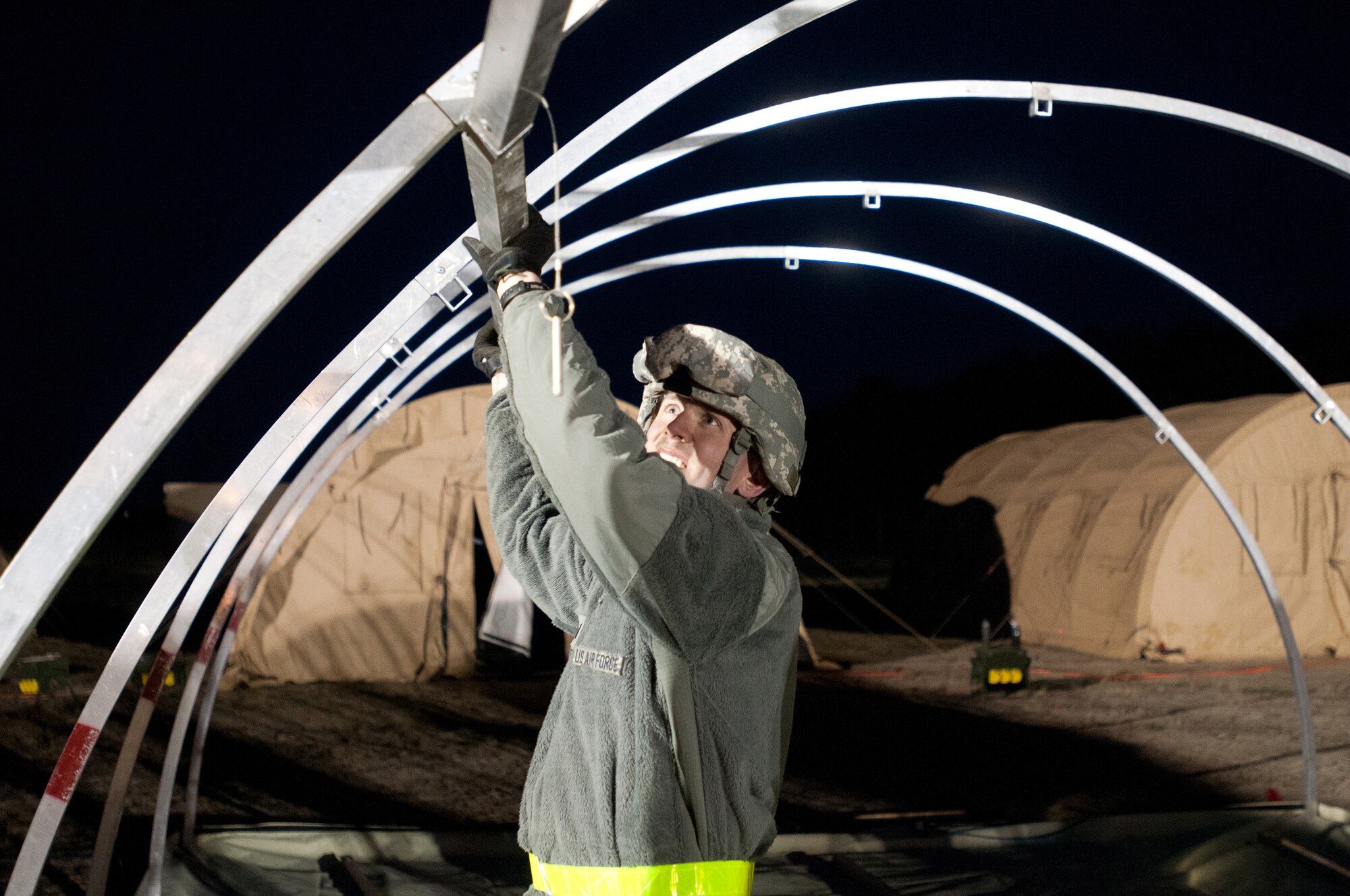 1st Lt. Kevin Eilers of the Kentucky Air National Guard's 123rd Contingency Response Group sets up an Alaskan Shelter tent at Joint Base McGuire-Dix-Lakehurst, N.J., March 26, 2012, during Exercise Eagle Flag. More than 80 Airmen from the Kentucky Air Guard have joined forces with over 50 active-duty Army troops and Air Guardsmen from New Jersey and Mississippi to establish an aerial port at Lakehurst Naval Air Engineering Station within 24 hours of arrival. Inspectors from U.S. Transportation Command will evaluate the performance of the Kentucky unit during the exercise. (U.S. Air Force photo by Master Sgt. Phil Speck)