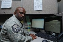 Master Sgt. Ben Jefferson, Air Force Personnel Center Benefits and Entitlements superintendent, a self proclaimed poet, sits at his work station on Joint Base San Antonio-Randolph March 28. MSgt. Jefferson has been writing poetry since his high school days in the 1980s.(U.S. Air Force photo by Rich McFadden) 