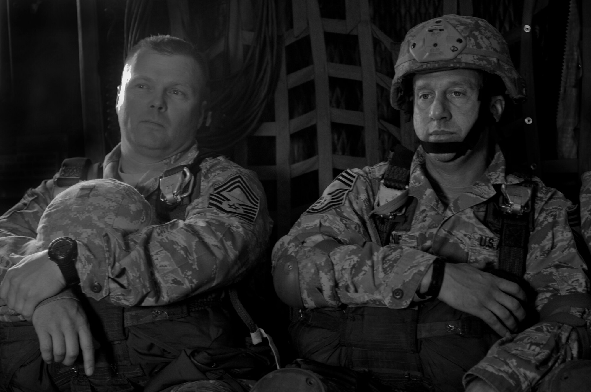 U.S. Air Force Chief Master Sgt. Tommy McDaniel and Chief Master Sgt. Artie Pearson, 820th Base Defense Group, relax before jumping out of an HC-130P Combat King at Moody Air Force Base Ga., March 21, 2012. McDaniel Graduated from the U.S. Army Basic Airborne Course on March 26, 2010. (U.S. Air Force photo by Airman 1st Class Douglas Ellis/Released)
