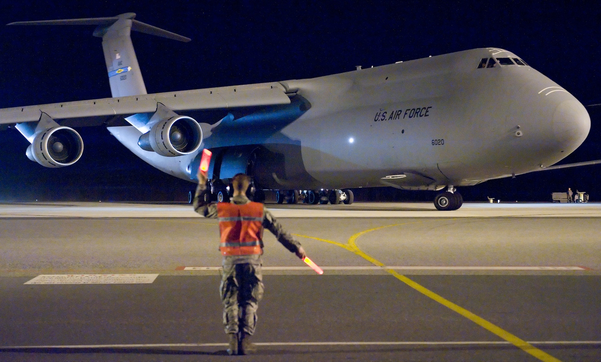 Airman 1st Class Aren Stinebuck, a crew chief with the 436th Aircraft Maintenance Squadron, marshals C-5B 86-0020 out of it's parking spot for a four-day mission March 8, 2012, at Dover Air Force Base, Del. This was the last active-duty C-5B mission flown at  Dover AFB. The 9th Airlift Squadron will now exclusively use the C-5M Super Galaxy for local training, state-side and overseas missions.  (U.S. Air Force photo by Roland Balik)