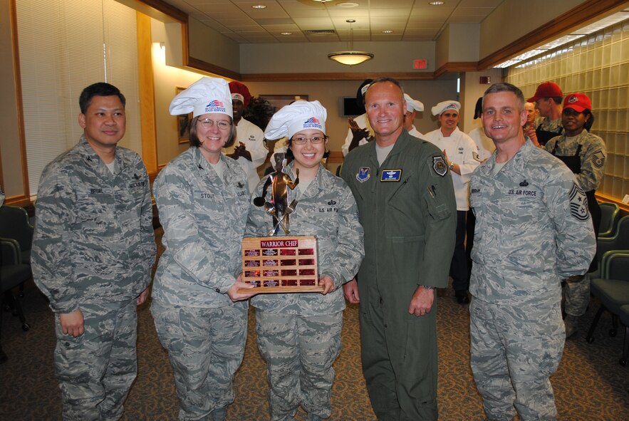 Winners of the Warrior Chef Competition, Col. Angela Stout, 341st Mission Support Group commander, second from left, and Tech. Sgt. Cleofe Van Orden, 341st Force Support Squadron dining facility NCO in charge, pose for a group photo with the competition judges Brig. Gen. James Brown, Air Force Global Strike Command command A-3, second from right, Col. H.B. Brual, 341st Missile Wing commander, far left, and Chief Master Sgt. Charles Anderson, 341st MW command chief, far right. (U.S. Air Force photo/Senior Airman Kristina Overton)