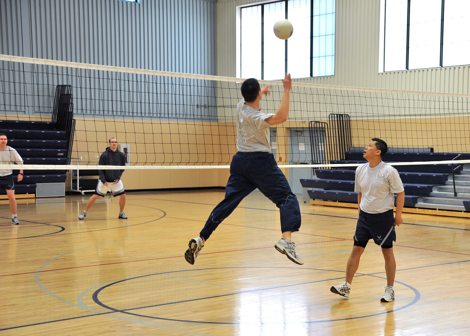 Capt. Nick Saccone, 819th RED HORSE Squadron project manager, spikes a ball to the opposing team as Col. H.B. Brual 341st Missile Wing commander, right, watches. The city-wide volleyball tournament will be between 10 teams, starting at 9 a.m. until 5 p.m. April 28. (U.S. Air Force photo/John Turner)