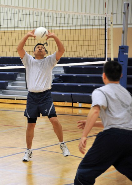 Brual, left, sets a ball as Saccone prepares to spike it. Malmstrom Air Force Base's Fitness Center will be hosting the first-ever city-wide six-on-six volleyball tournament April 28. (U.S. Air Force photo/John Turner)