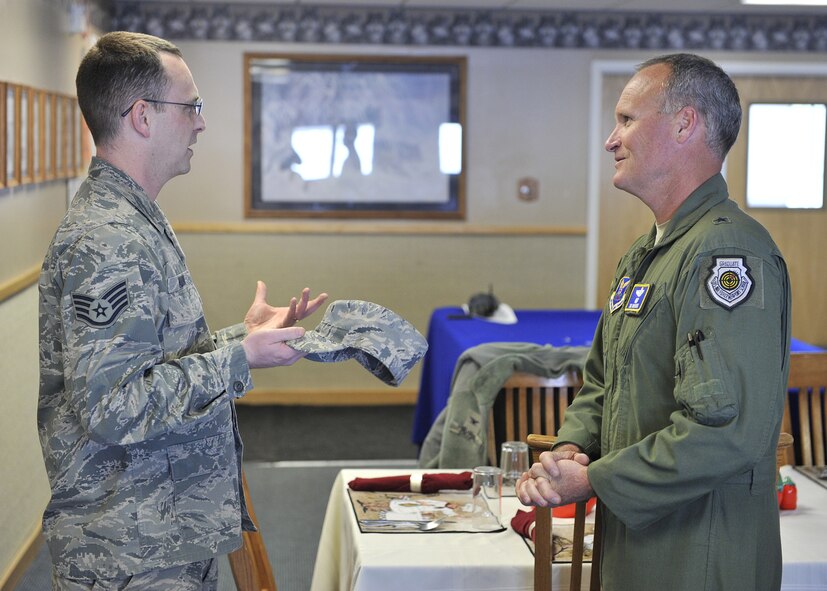 Staff Sgt. Christopher Amann, 10th Missile Squadron facility manager at Alpha Missile Alert Facility, briefs Browne Brig. Gen. James Browne during his stop there for lunch March 28. (U.S. Air Force photo/John Turner)