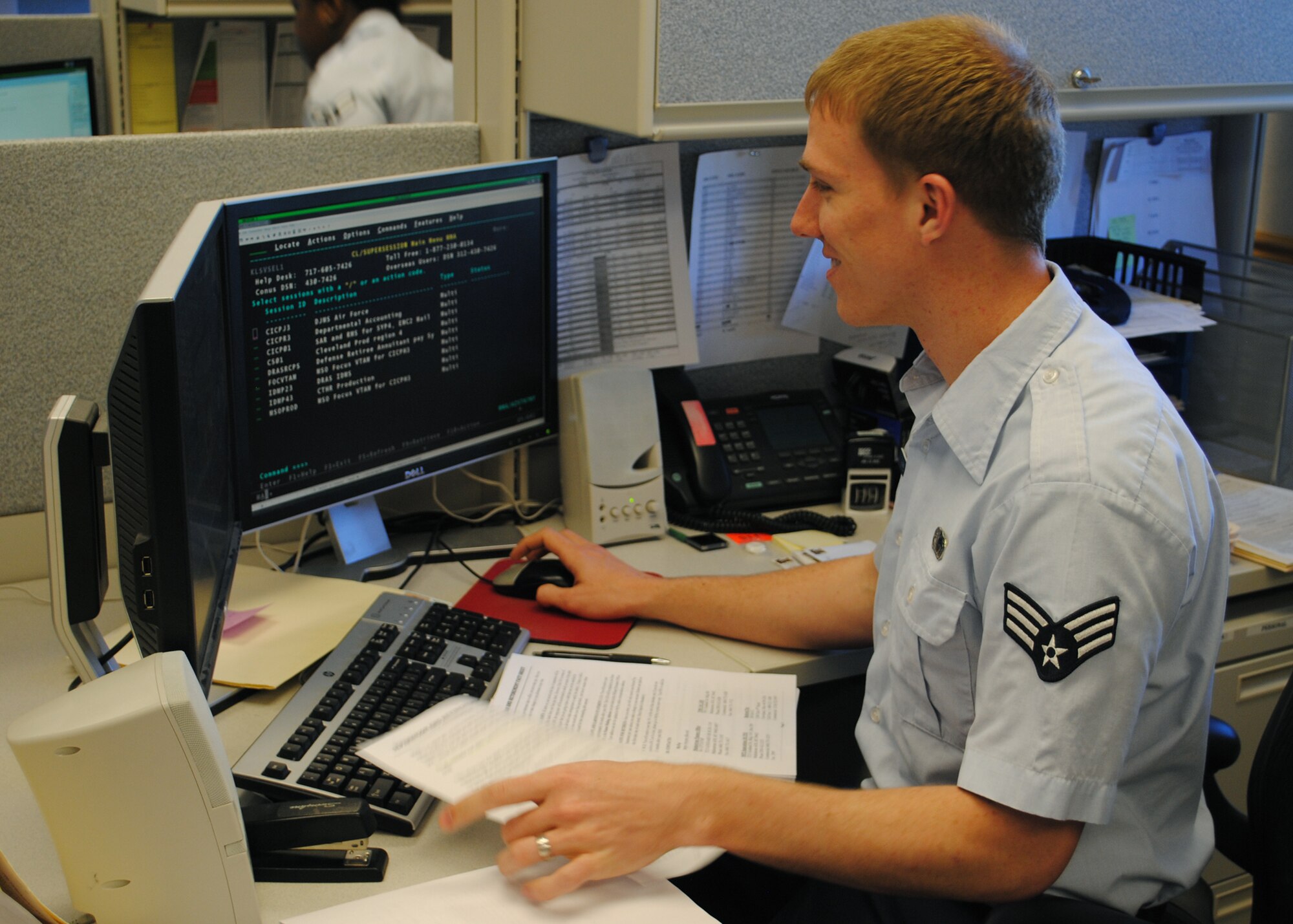 Senior Airman Robert Sharpe, 341st Comptroller Squadron finance technician, goes over some paperwork for a member's separation. (U.S. Air Force photo/Airman 1st Class Cortney Paxton)