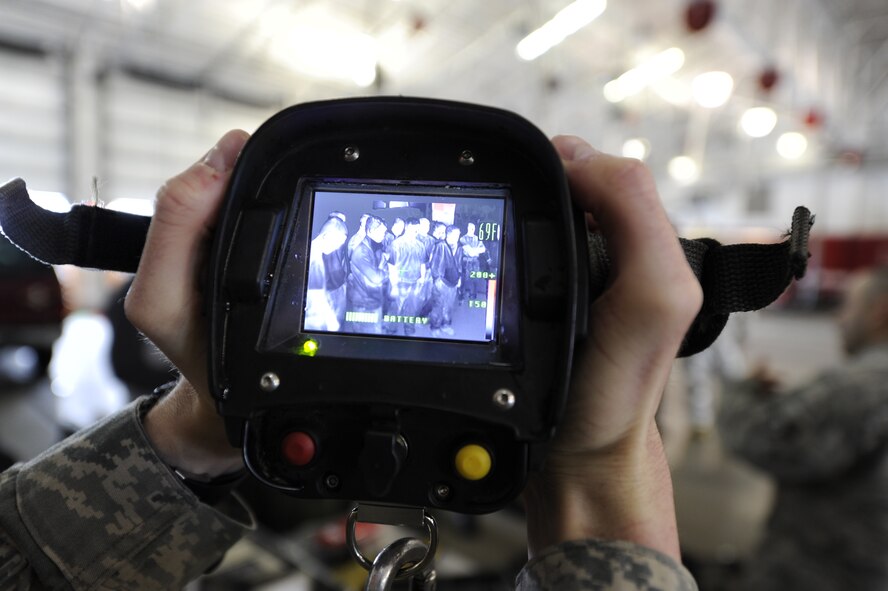 Oroville, Wash., Border Patrol Explorer students had an opportunity to experience a thermal vision camera during their tour of the firehouse at Fairchild Air Force Base, Wash., April 4, 2012. Thermal vision can detect hot spots allowing firefighters to gather information about a scene before they enter. (U.S. Air Force photo by Airman 1st Class Ryan Zeski/Released)