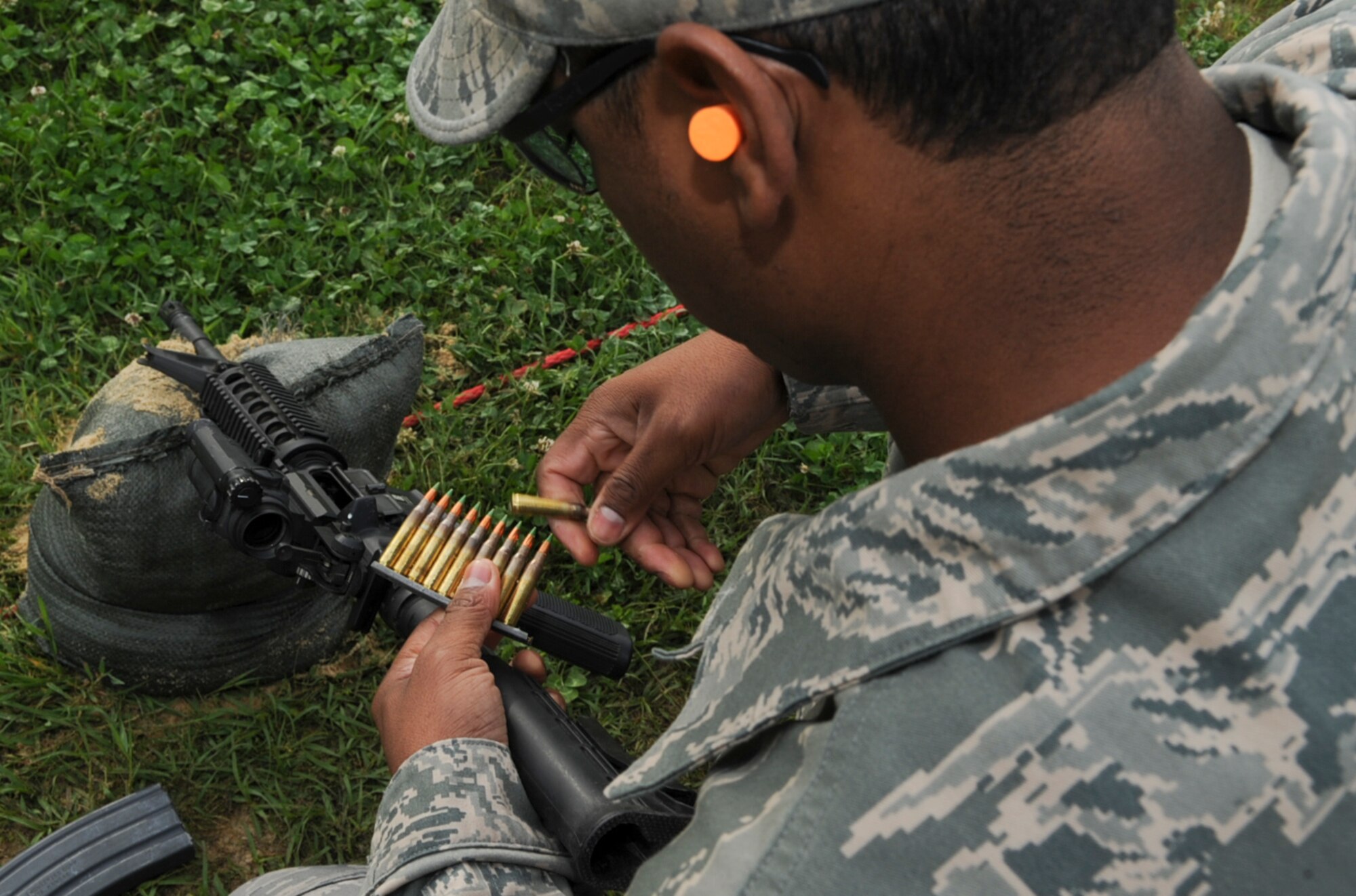 U.S. Air Force Tech. Sgt. William Dunston prepares to load a 30 round magazine before qualifying on the M4 carbine at Howell Woods Firing Range in Smithfield, N.C., April 10, 2012. The M4 carbine is a gas-operated, air-cooled, magazine-fed, selective fire, shoulder-fired weapon with a telescoping stock commonly used by the U.S. military. Dunston, 4th Equipment Maintenance Squadron flightline munitions superintendent, hails from Philadelphia. (U.S. Air Force photo/Airman 1st Class Aubrey Robinson/Released)