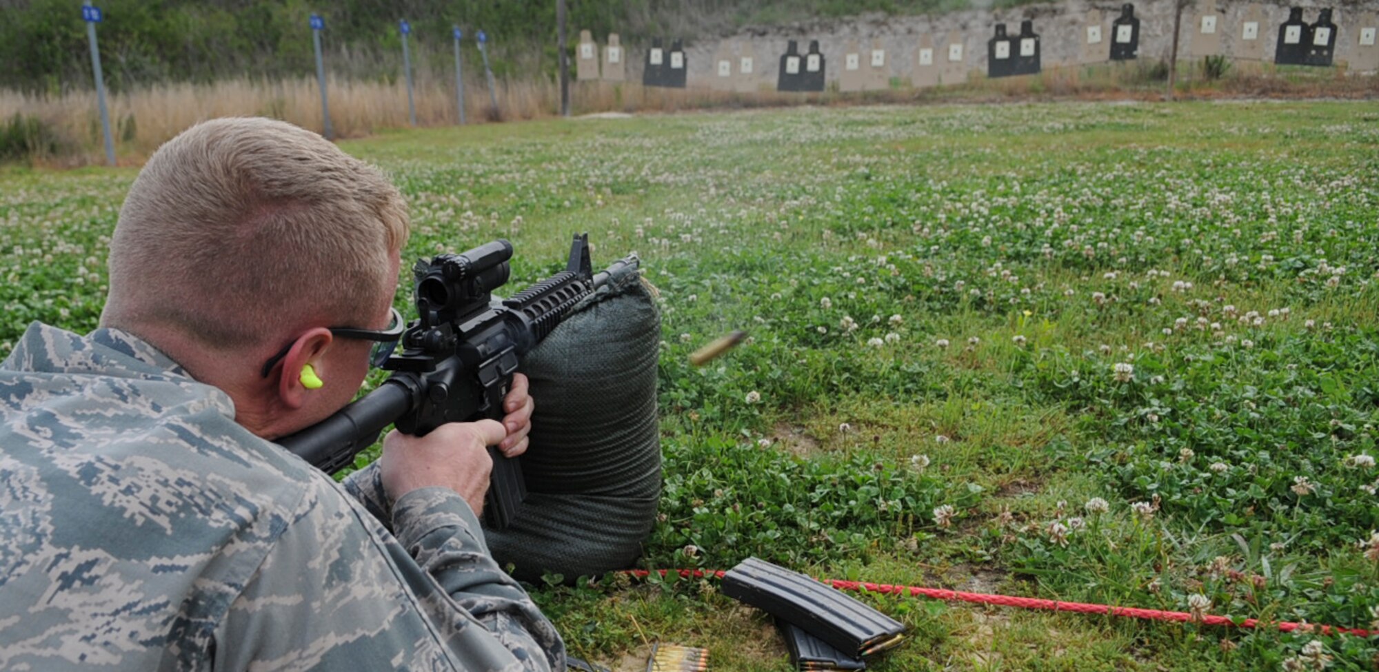 U.S. Air Force Senior Airman Shane Johnson fires an M4 carbine at Howell Woods Firing Range in Smithfield, N.C., April 10, 2012. Johnson fired 50 rounds in the prone position, 25 of his rounds must land on target to qualify on the weapon. Johnson, 4th Equipment Maintenance Squadron equipment maintenance crew member, hails from Indianapolis. (U.S. Air Force photo/Airman 1st Class Aubrey Robinson/Released)