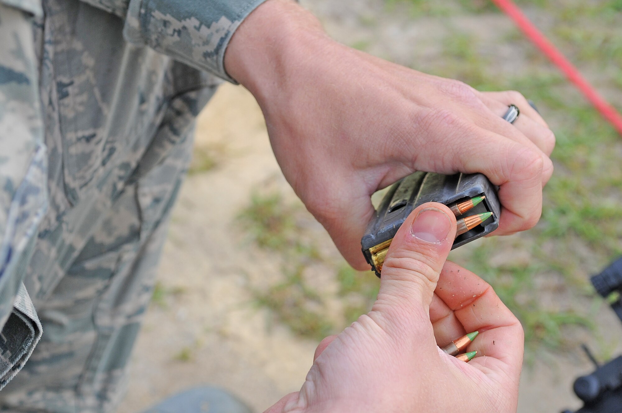 U.S. Air Force Senior Airman Aaron Jordan loads 5.56mm rounds into a magazine at Howell Woods Firing Range in Smithfield, N.C., April 9, 2012. Jordan is attending the combat arms training and maintenance course where he will become familiar with the functions of his M4 carbine. Jordan, 4th Equipment Maintenance Squadron munitions technician, hails from Barker, N.Y. (U.S. Air Force photo/Senior Airman Gino Reyes/Released)