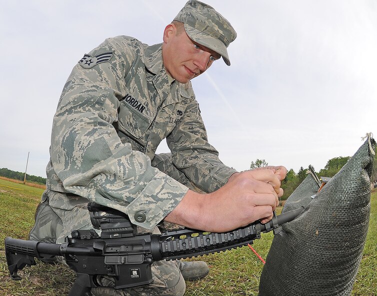 U.S. Air Force Senior Airman Aaron Jordan adjusts the front-site post on his M4 Carbine at Howell Woods Firing Range in Smithfield, N.C., April 9, 2012. Airmen qualify by firing 50 rounds and must effectively hit their targets at least 25 times. Jordan, 4th Equipment Maintenance Squadron munitions technician, hails from Barker, N.Y. (U.S. Air Force photo/Senior Airman Gino Reyes/Released)