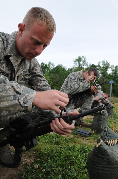 U.S. Air Force Senior Airman Shane Johnson adjusts the front sight post on his M4 carbine for a more accurate shot at Howell Woods Firing Range in Smithfield, N.C., April 10, 2012. Johnson is taking a combat arms training and maintenance course to assist in qualifying on the M4 carbine. Johnson, 4th Equipment Maintenance Squadron equipment maintenance crew member, hails from Indianapolis. (U.S. Air Force photo/Airman 1st Class Aubrey Robinson/Released)