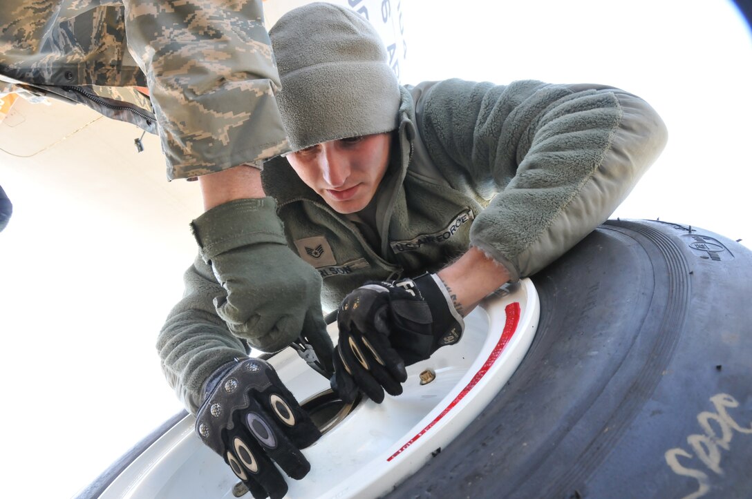 Staff Sgt. Cody Carlson, a Crew Chief assigned to U.S. Air Force aircraft 80104, a KC-135R Stratotanker, assists with replacing bearings in a new nose gear tire before installing it on April 10, 2012. Staff Sgt. Carlson, from Sandwich, Ill., is assigned to the 126th Maintenance Squadron, a unit with the 126th Air Refueling Wing, Illinois National Guard, at Scot AFB, Ill. Crew chiefs perform and oversee everyday maintenance to aircraft. They recover and inspect aircraft after a flight, change tires and brakes, service engine oil and hydraulic fluid, and execute numerous inspections. They ensure an aircraft is safe and reliable. (National Guard photo by Master Sgt. Ken Stephens)
