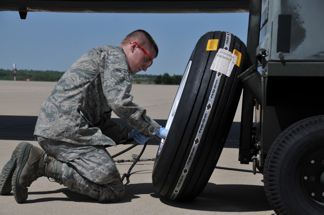 Airman Kevin O'Reilly, a Crew Chief assigned to U.S. Air Force aircraft 80104, a KC-135R Stratotanker, connects an inline pressure gauge to a nose gear tire on April 10, 2012. Airman O'Reilly, from Laingsburg, Mich., is assigned to the 906th Air Refueling Squadron, an active duty Air Force unit that is associated with the 126th Air Refueling Wing, Illinois National Guard, at Scot AFB, Ill. Crew chiefs perform and oversee everyday maintenance to aircraft. They recover and inspect aircraft after a flight, change tires and brakes, service engine oil and hydraulic fluid, and execute numerous inspections. They ensure an aircraft is safe and reliable. (National Guard photo by Master Sgt. Ken Stephens)