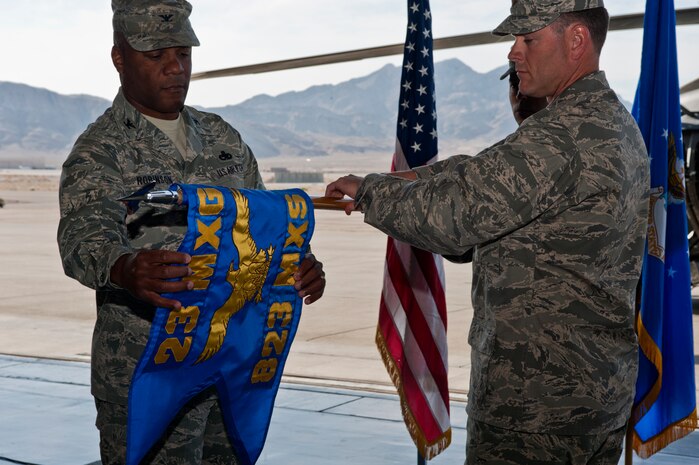 U.S. Air Force Colonel Neal Robinson, 23rd Maintenance Group commander, Moody Air Force Base, Ga., and Maj. Louis Cumming, 823rd Maintenance Squadron commander, activate the 823rd Maintenance Squadron April 10, 2012, at Nellis Air Force Base, Nev. The 763rd MXS was replaced by the 823rd MXS effective April 10, 2012. (U.S. Air Force photo by Airman 1st Class Jason Couillard)