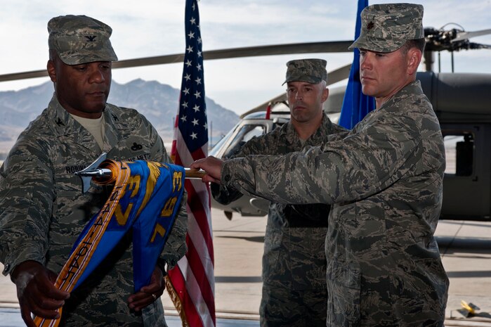 U.S. Air Force Colonel Neal Robinson, 23rd Maintenance Group commander, Moody Air Force Base, Ga., and Maj. Louis Cumming, 763rd Maintenance Squadron commander, deactivate the 763rd Maintenance Squadron April 10, 2012, at Nellis Air Force Base, Nev. The 763rd MXS was replaced by the 823rd MXS effective April 10, 2012. (U.S. Air Force photo by Airman 1st Class Jason Couillard)