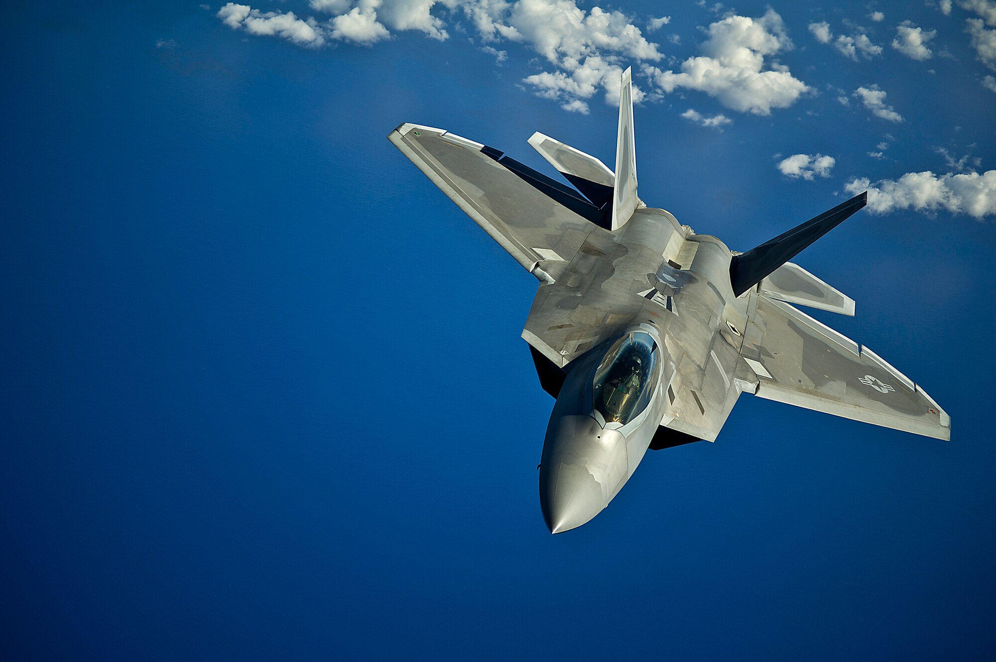 An F-22 Raptor from the Hawaii Air National Guard’s 199th Fighter Squadron returns to a training mission after refueling March 27, 2012, over the Pacific Ocean near the Hawaiian Islands. During the training, U.S. Air Force Academy cadets received a familiarization flight to get a better understanding of the Air Force's global reach capabilities. (U.S. Air Force photo/Tech. Sgt. Michael Holzworth)