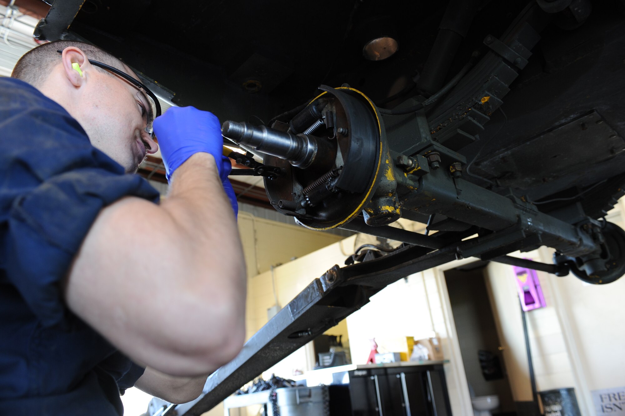 U.S. Air Force Airman 1st Class Kenneth Langelier removes a bolt on a munitions handling unit 110 in an equipment maintenance building on Seymour Johnson Air Force Base, N.C., April 9, 2012. A MHU 110 is a 10-wheeled trailer that is primarily used to transport munitions and can move up to 15,000 pounds. Langelier, 4th Equipment Maintenance Squadron munitions systems support equipment maintainer, hails from Big Bear, Calif. (U.S. Air Force photo/Airman 1st Class John Nieves Camacho/Released)
