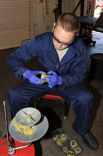 U.S. Air Force Airman 1st Class Zachary Colman applies grease to a munitions handling unit 141 wheel bearing in an equipment maintenance building on Seymour Johnson Air Force Base, N.C., April 9, 2012. Colman greases the bearings to prevent the tires from locking and to avoid damage to the brakes. Colman, 4th Equipment Maintenance Squadron munitions systems support equipment maintainer, is a native of Livonia, Mich. (U.S. Air Force photo/Airman 1st Class John Nieves Camacho/Released) 