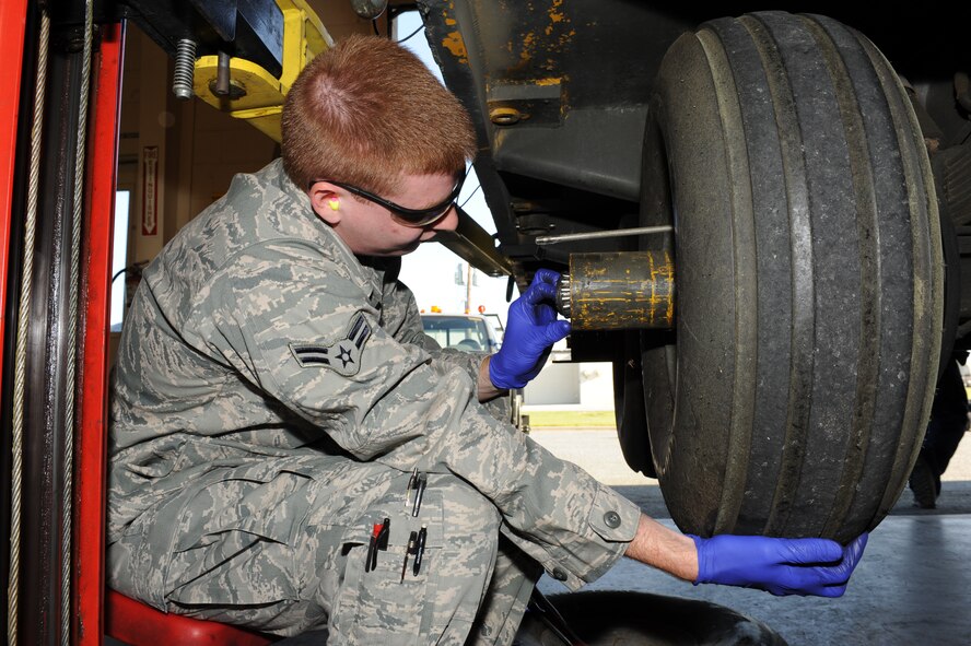 U.S. Air Force Airman 1st Class Bradley Snyder removes a wheel bearing from a munitions handling unit 110 in an equipment maintenance building on Seymour Johnson Air Force Base, N.C., April 9, 2012. The MHU 110 has 10 tires in addition to brake drums and tire hubs which receive annual quality assurance checks. Bradley, 4th Equipment Maintenance Squadron munitions systems support equipment maintainer, is from Moyock, N.C. (U.S. Air Force photo/Airman 1st Class John Nieves Camacho/Released)