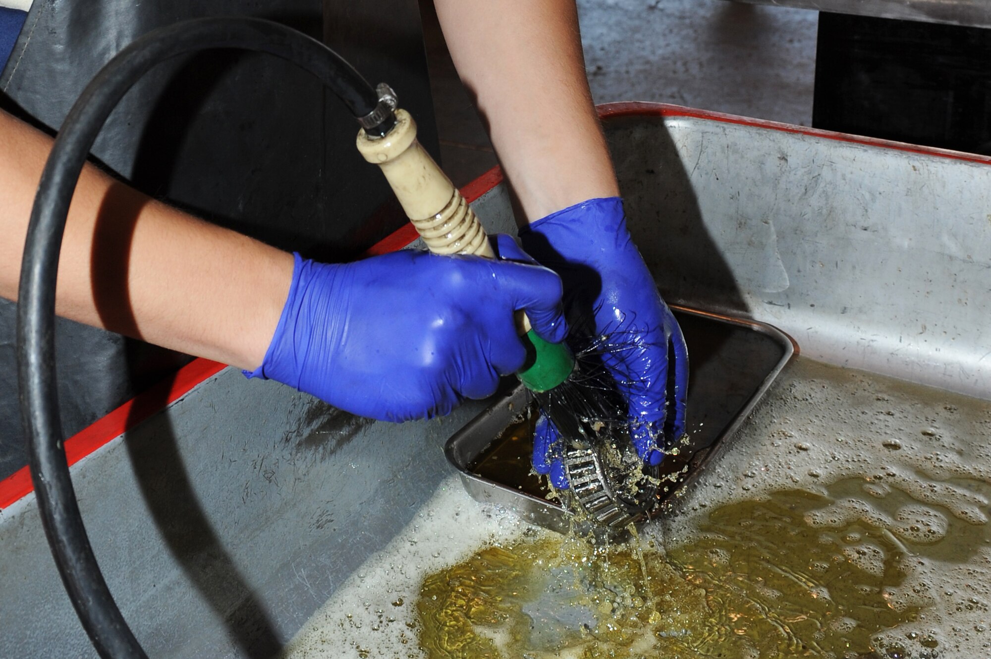 U.S. Air Force Airman 1st Class Zachary Colman cleans a munitions handling unit wheel bearing in an equipment maintenance building on Seymour Johnson Air Force Base, N.C., April 9, 2012. The bearing allows wheels to rotate while supporting a vehicle’s weight and should be cleaned annually to avoid damage. Colman, 4th Equipment Maintenance Squadron munitions systems support equipment maintainer, hails from Livonia, Mich. (U.S. Air Force photo/Airman 1st Class John Nieves Camacho/Released)