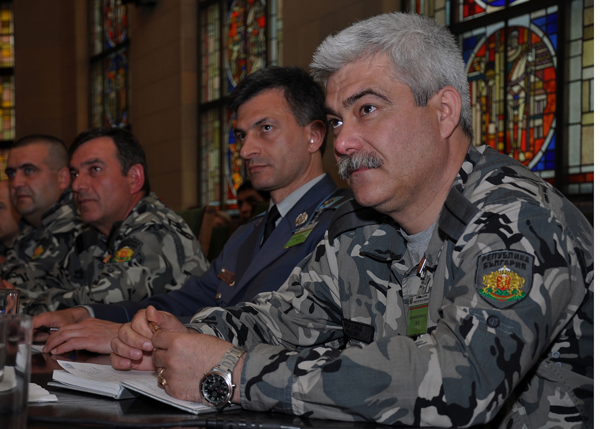 Bulgarian air force chiefs Master Sgt. Hristo Hristozoz and Ivo Bakardzhiev listen to a presentation during the first Bulgarian and U.S. non-commissioned officer symposium at the Bulgarian Land Forces headquarters here, April 10-11. More than 40 senior enlisted leaders met to discuss doctrine, strengths and leadership philosophies, which are designed to empower and inspire non-commissioned officers in both nations' corps. The first day of the joint-nation symposium included four discussions and a small-group breakout session.