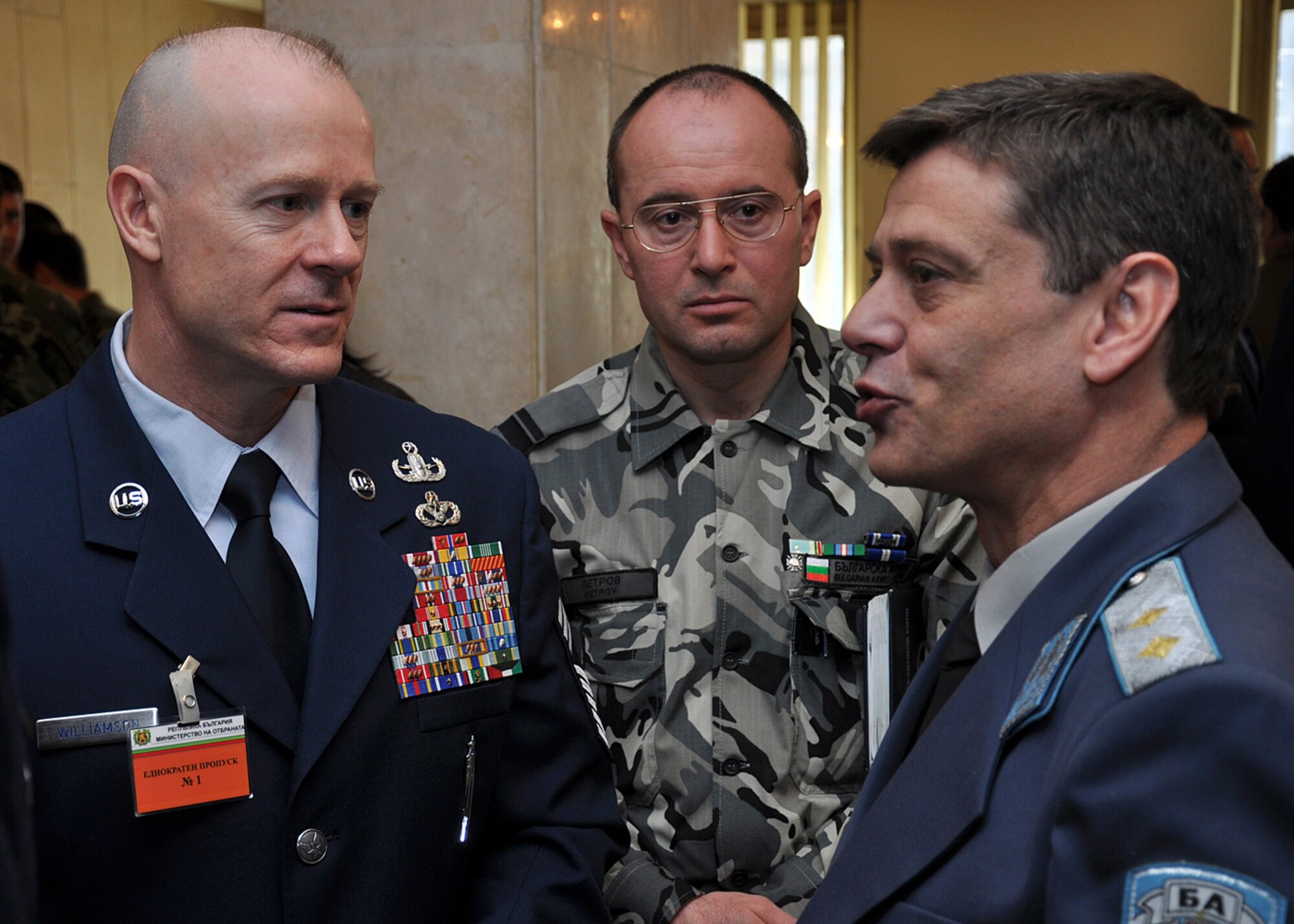 U.S. Air Forces in Europe Command Chief Master Sgt. David Williamson, (left) and Bulgarian air force Sgt. Maj. Rumen Petrov (center) listen to Bulgarian Chief of air forces Maj. Gen. Constantin Veselinov Popov during the first Bulgarian and U.S. non-commissioned officer symposium at the Bulgarian Land Forces headquarters here, April 10-11. More than 40 senior enlisted leaders met to discuss doctrine, strengths and leadership philosophies, which are designed to empower and inspire non-commissioned officers in both nations' corps. The first day of the joint-nation symposium included four discussions and a small-group breakout session.