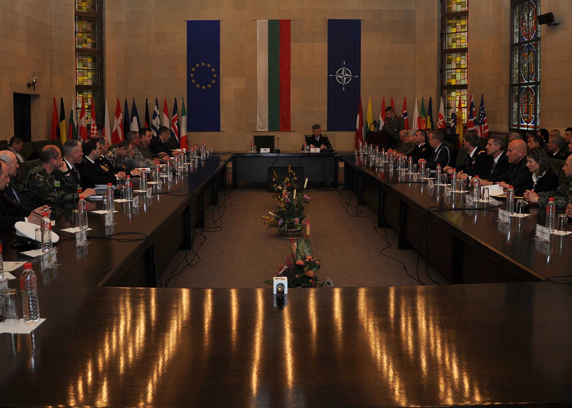Bulgarian navy Vice Adm. Plamen Manushev, deputy chief of defense (center), prepares opening remarks before the first Bulgarian and U.S. non-commissioned officer symposium begins at the Bulgarian Land Forces headquarters here, April 10-11. More than 40 senior enlisted leaders met to discuss doctrine, strengths and leadership philosophies, which are designed to empower and inspire non commissioned officers in both nations' corps. The first day of the joint-nation symposium included four discussions and a small-group breakout session.