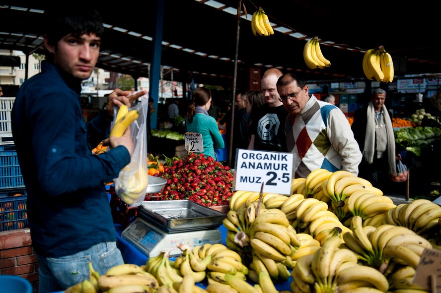Mehmet Birbiri and Senior Airman Clayton Lenhardt, 39th Air Base Wing Public Affairs, stop at a fruit stand during a trip to a farmers market March 8, 2012, in Adana, Turkey. The fertile soil around Adana allows farmers to grow many types of produce, keeping prices low and fruits and vegetables fresh. (U.S. Air Force photo by Tech. Sgt. Michael B. Keller/Released)
