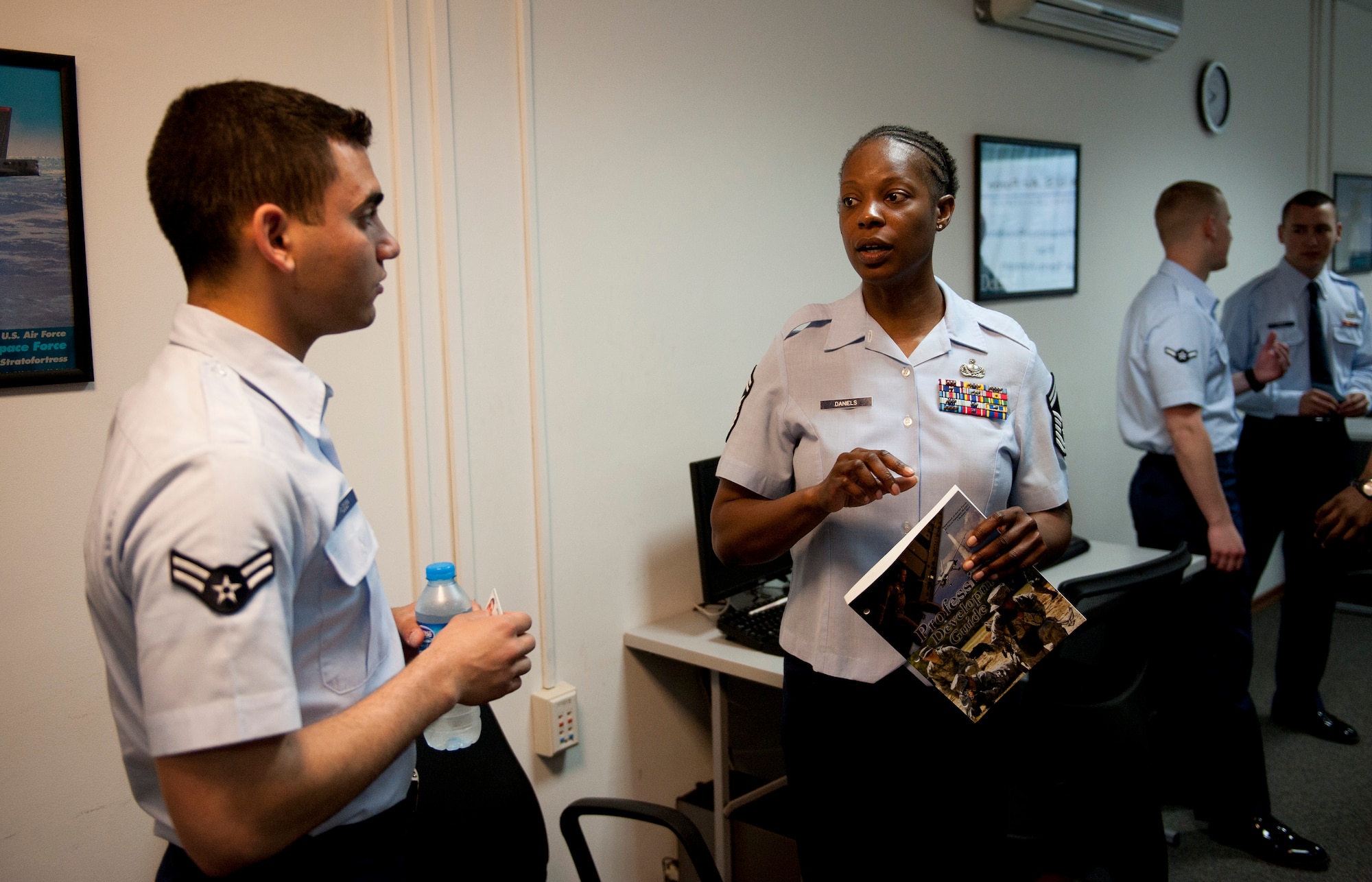 Senior Master Sgt. Ouida Daniels, right, 39th Force Support Squadron career advisor, talks to an Airman prior to a briefing April 9, 2012, at Incirlik Air Base, Turkey. As the career advisor, Daniels assists Incirlik Airmen by helping find special duties in their career fields, explaining how cross training works and the eligibility requirements to cross train, relaying the options one has when separating from the Air Force, and showing where to find information on writing resumes and other skills. (U.S. Air Force photo by Senior Airman William A. O'Brien/Released) 